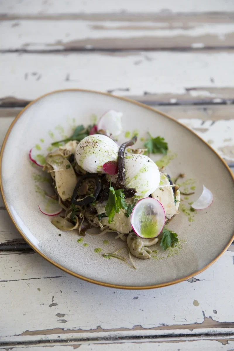 Poached free range eggs with hummus and mushrooms.
