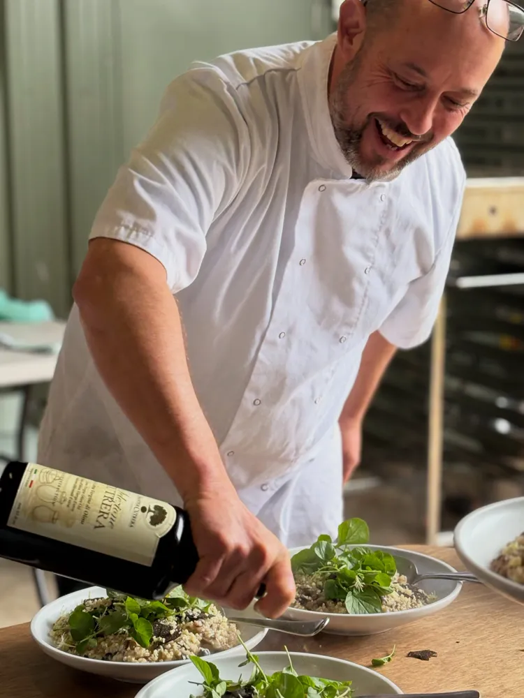 David Lee, Sydney chef and hospitality consultant, finishing plates with olive oil